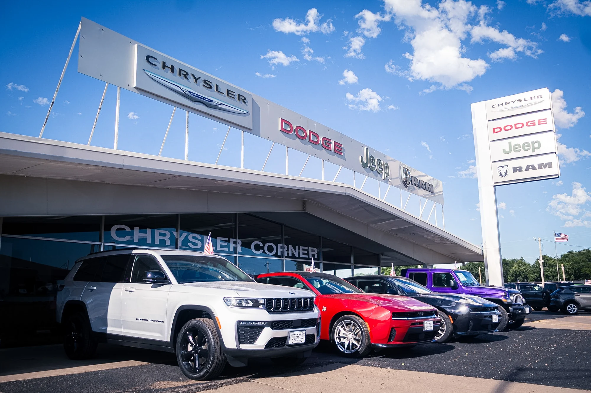 The Chrysler Corner dealership frontage, canopy signage and vehicle lineup in Liberal, Kansas
