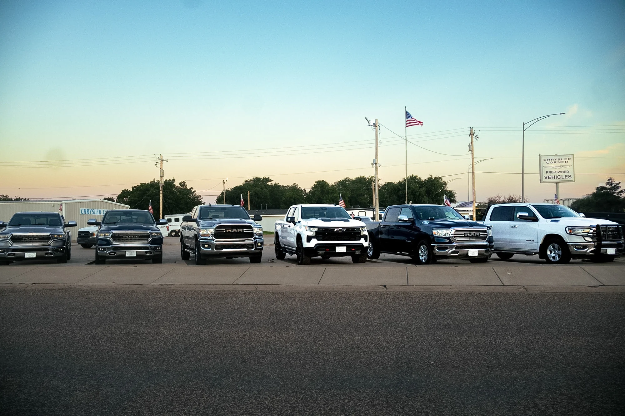 Trucks lined up along the road at Chrysler Corner at dusk