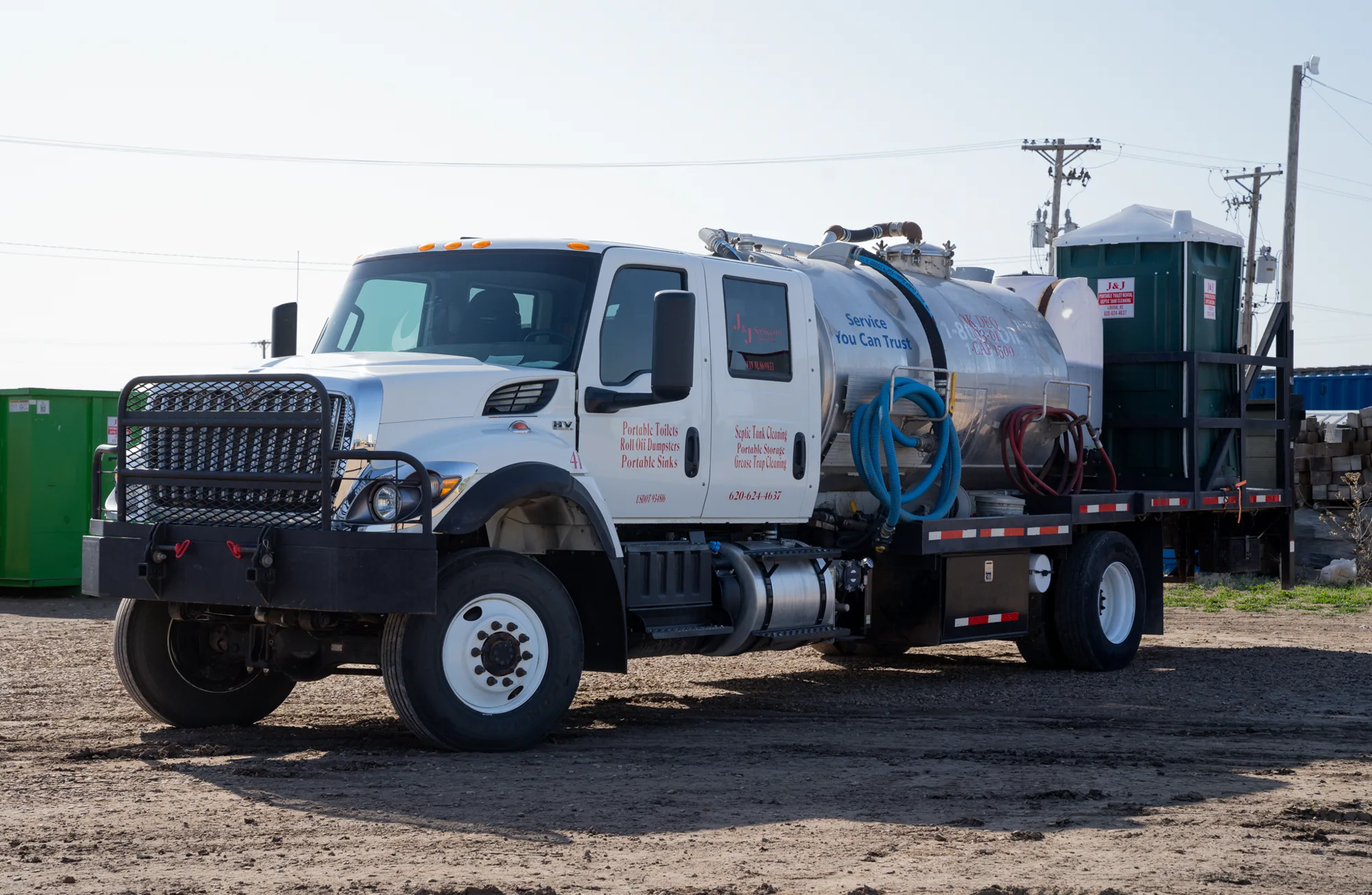 A J and J Services LLC service truck rigged with a tank and hose reel