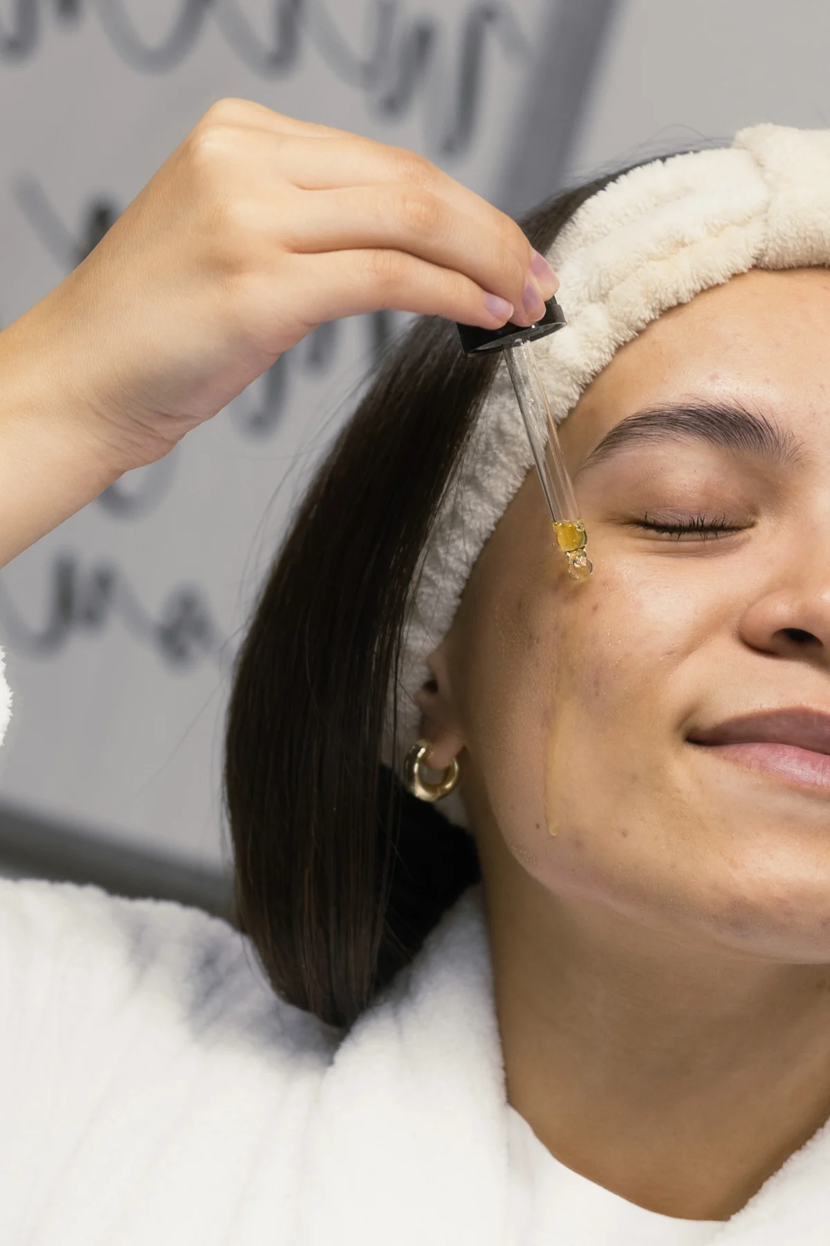 Reclaiming Dawn face serum applied with a dropper