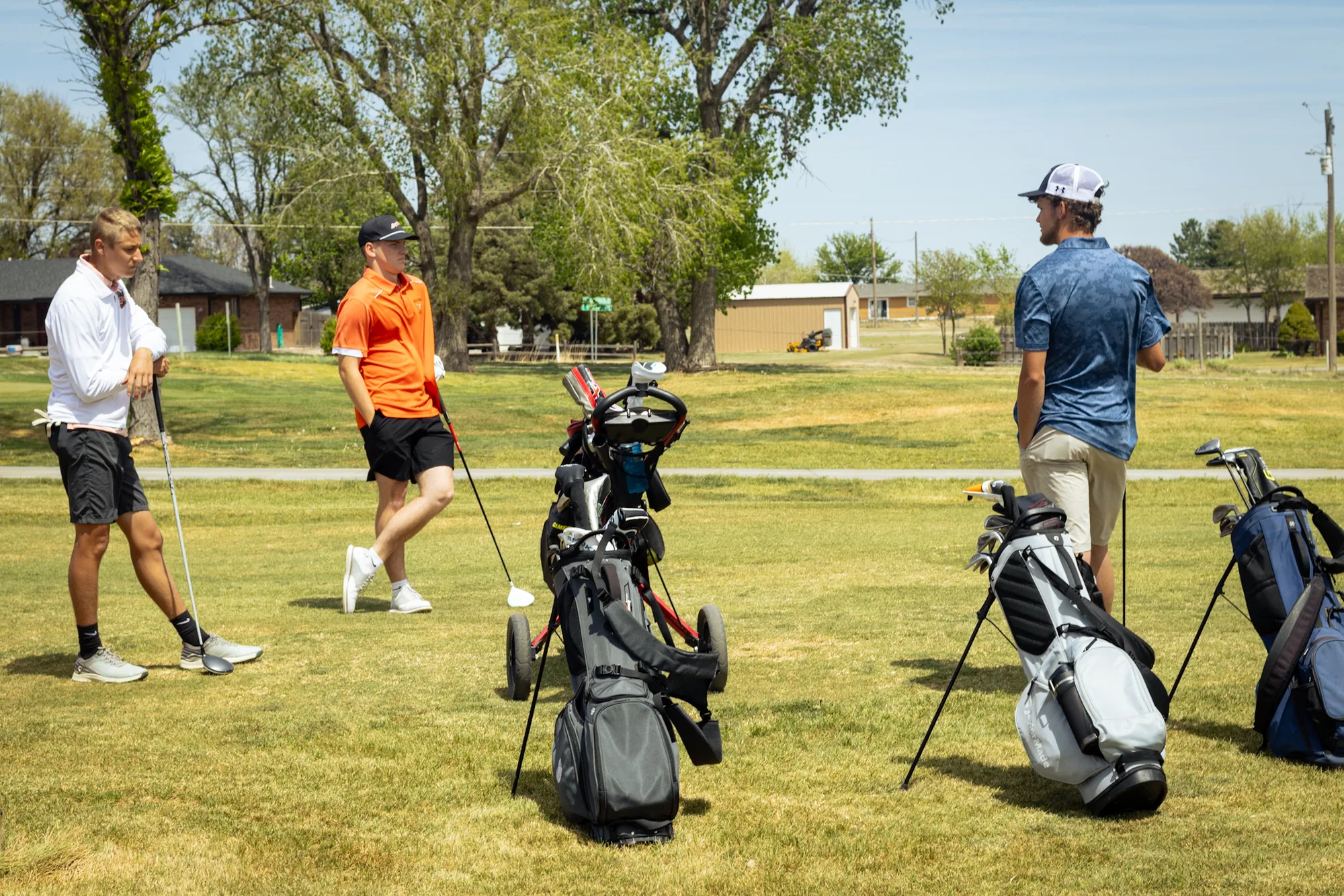 Three golfers walking Bentwood Golf Course with their bags