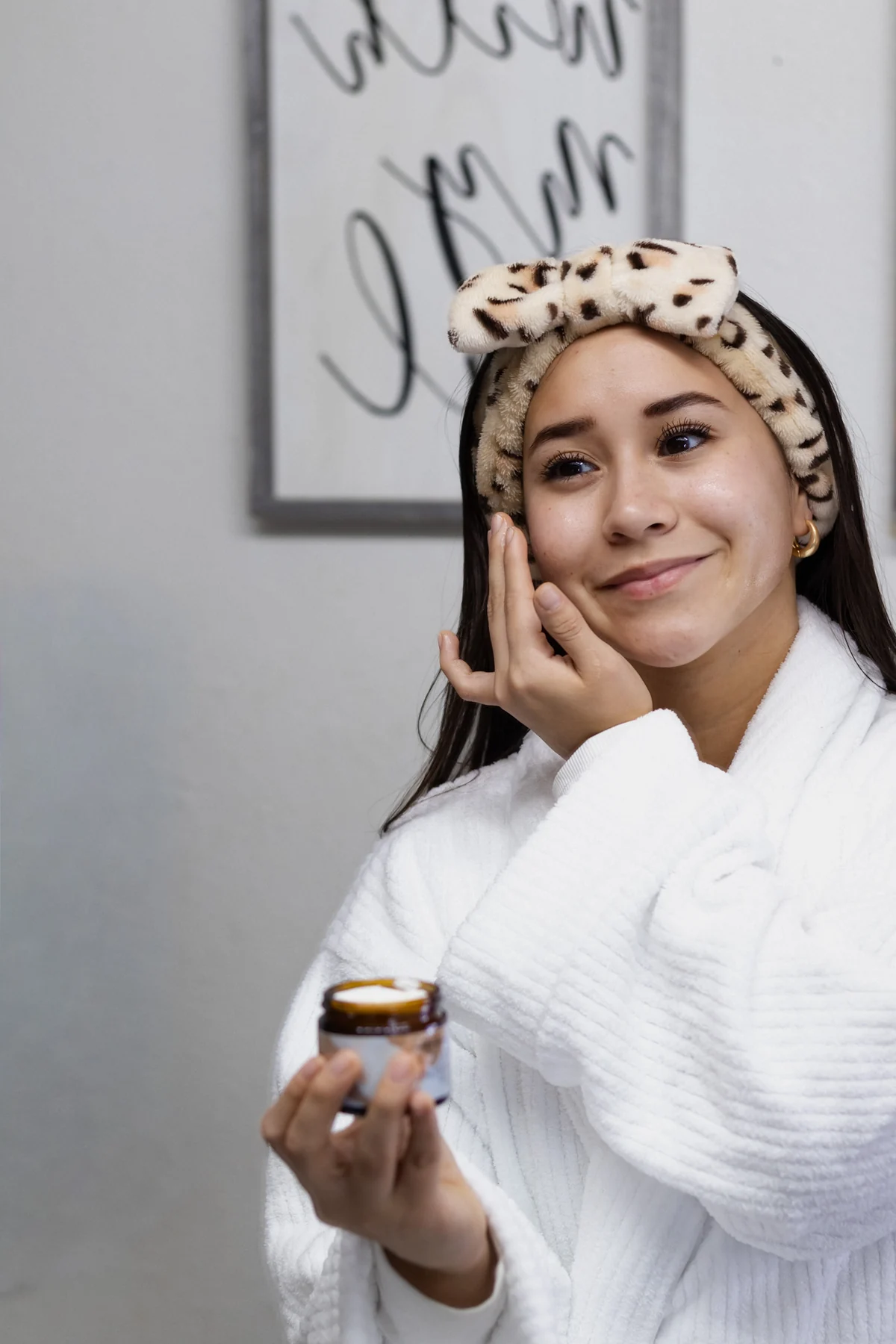 Model holding a Reclaiming Dawn moisturizer jar