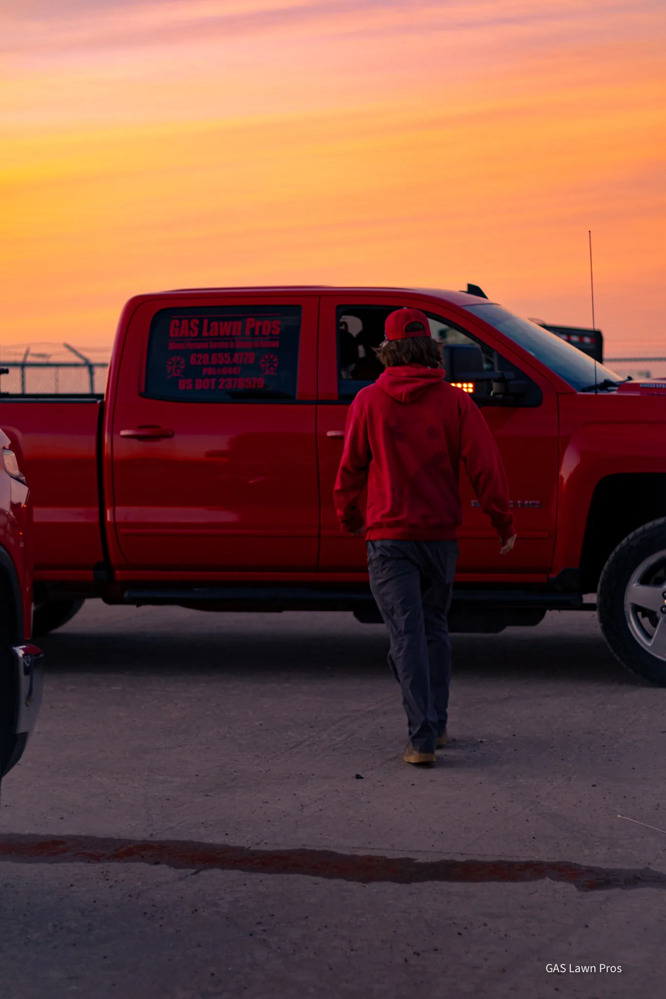 GAS Lawn Pros branded truck and employee at golden hour