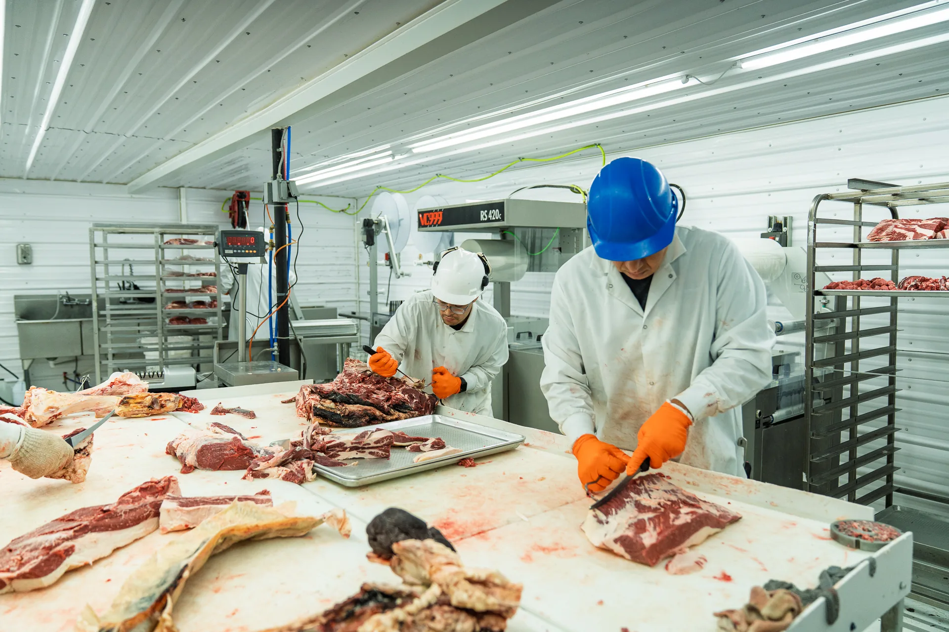 Two Hat Creek Butchery team members working the cutting room together