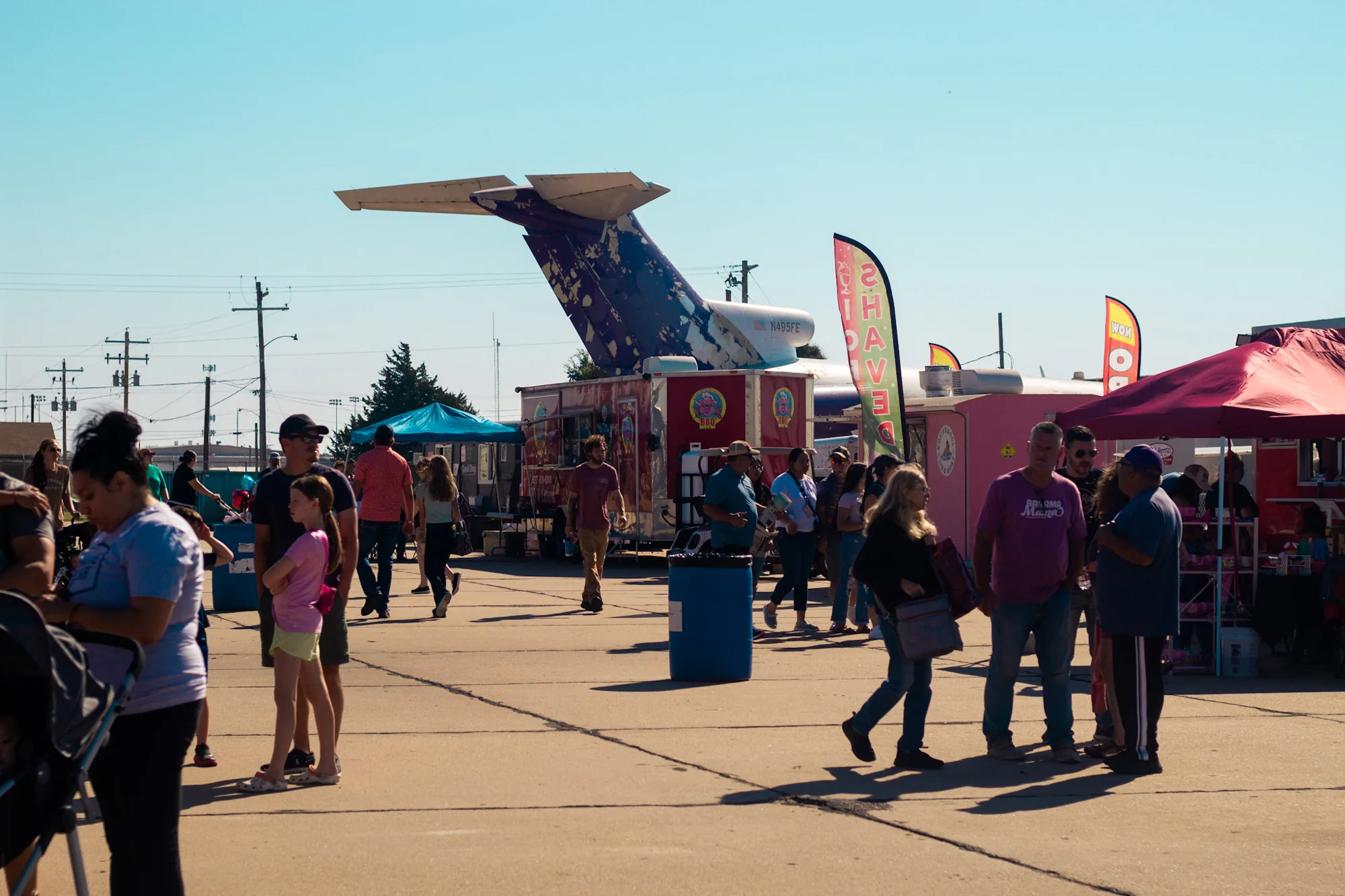 Crowd walking the flight line among aircraft at the Liberal Air Fair