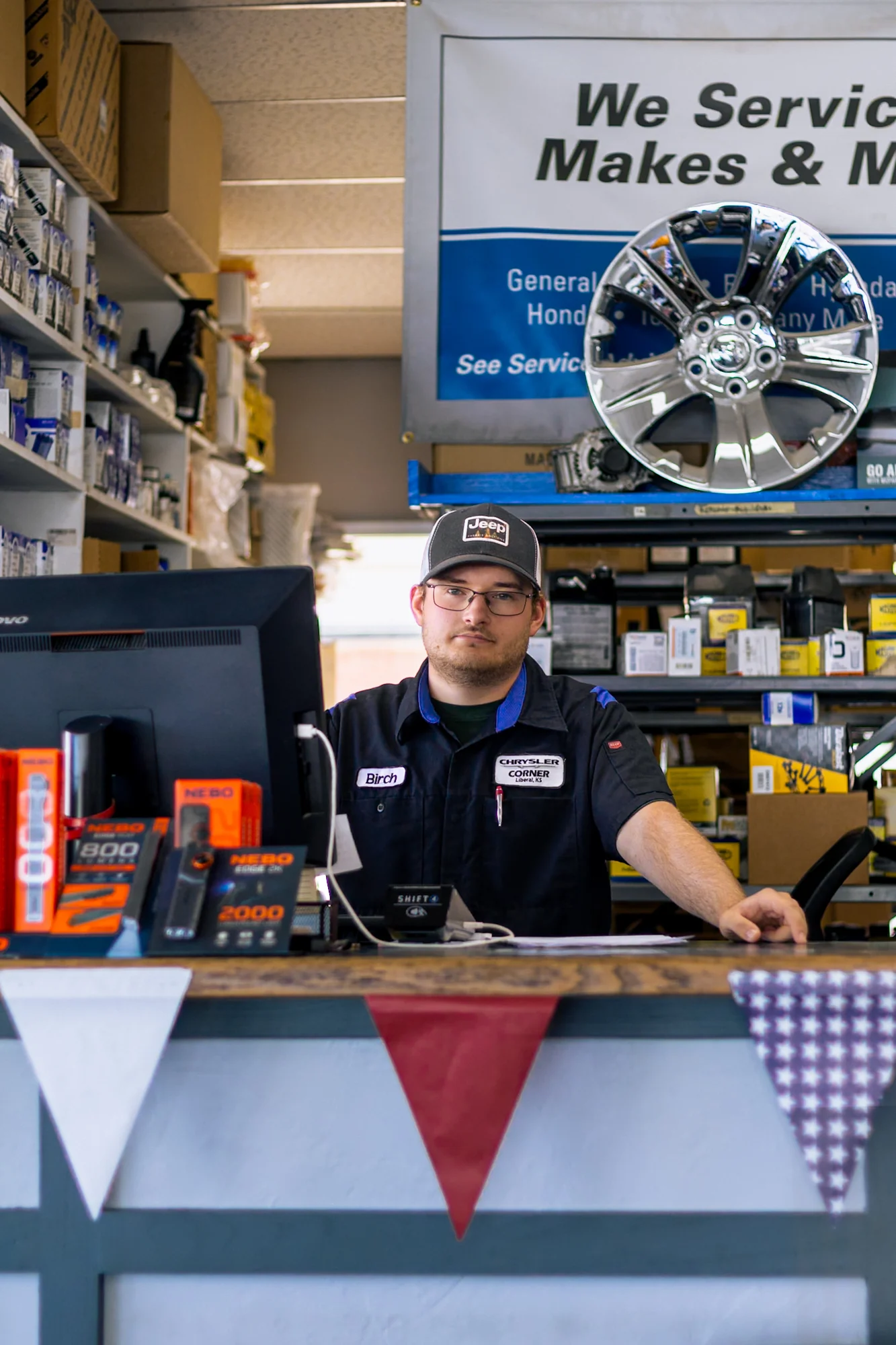A Chrysler Corner parts staff member behind the counter
