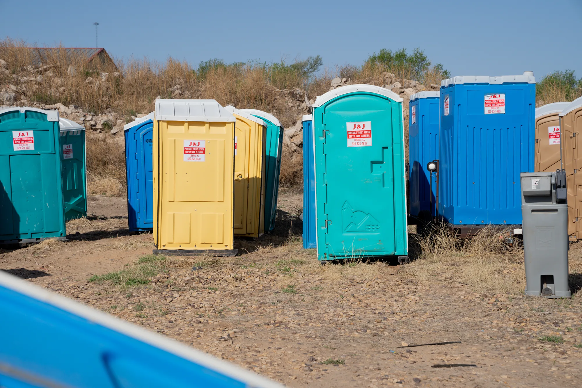Rows of portable sanitation units in the J and J Services LLC inventory yard